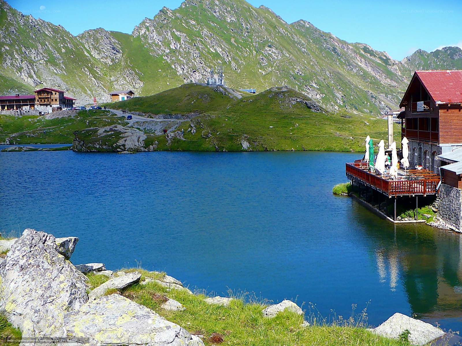 Mountain lake with wooden lodge