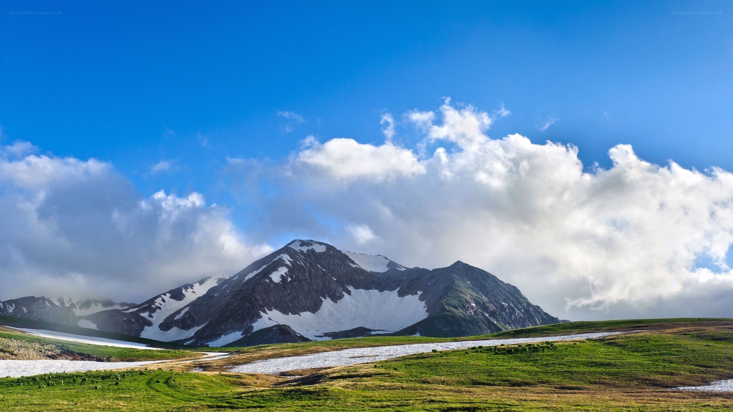 Mountain landscape with snow and clouds