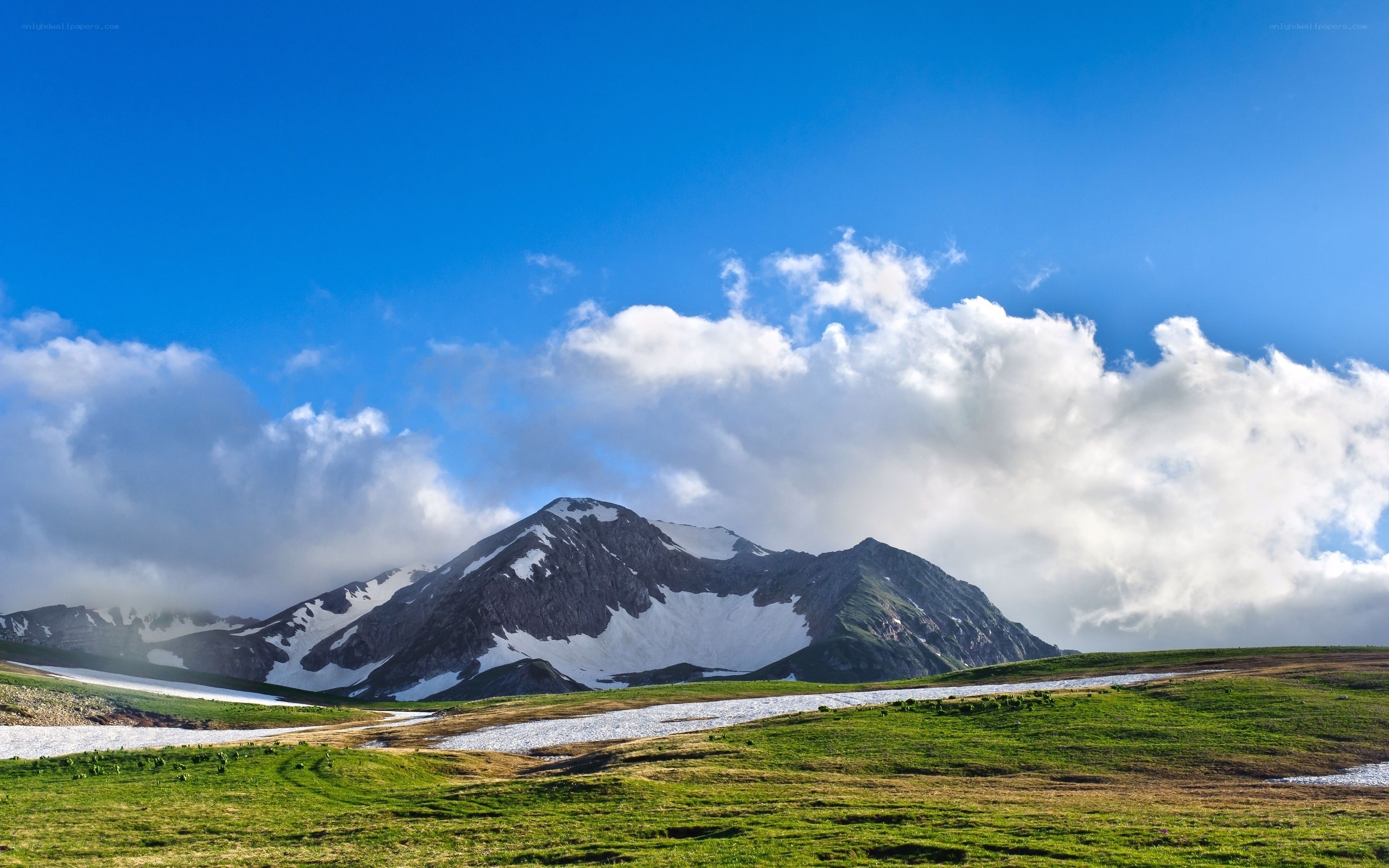 Mountain landscape with snow and clouds