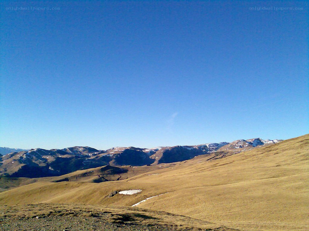 Mountain landscape with snow patches