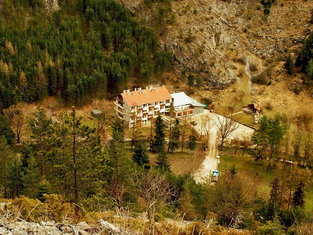 Mountain lodge in forested valley