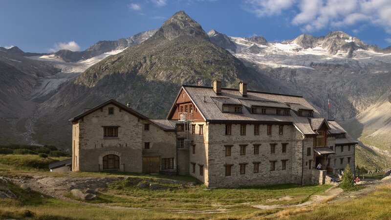 Mountain lodge with alpine backdrop