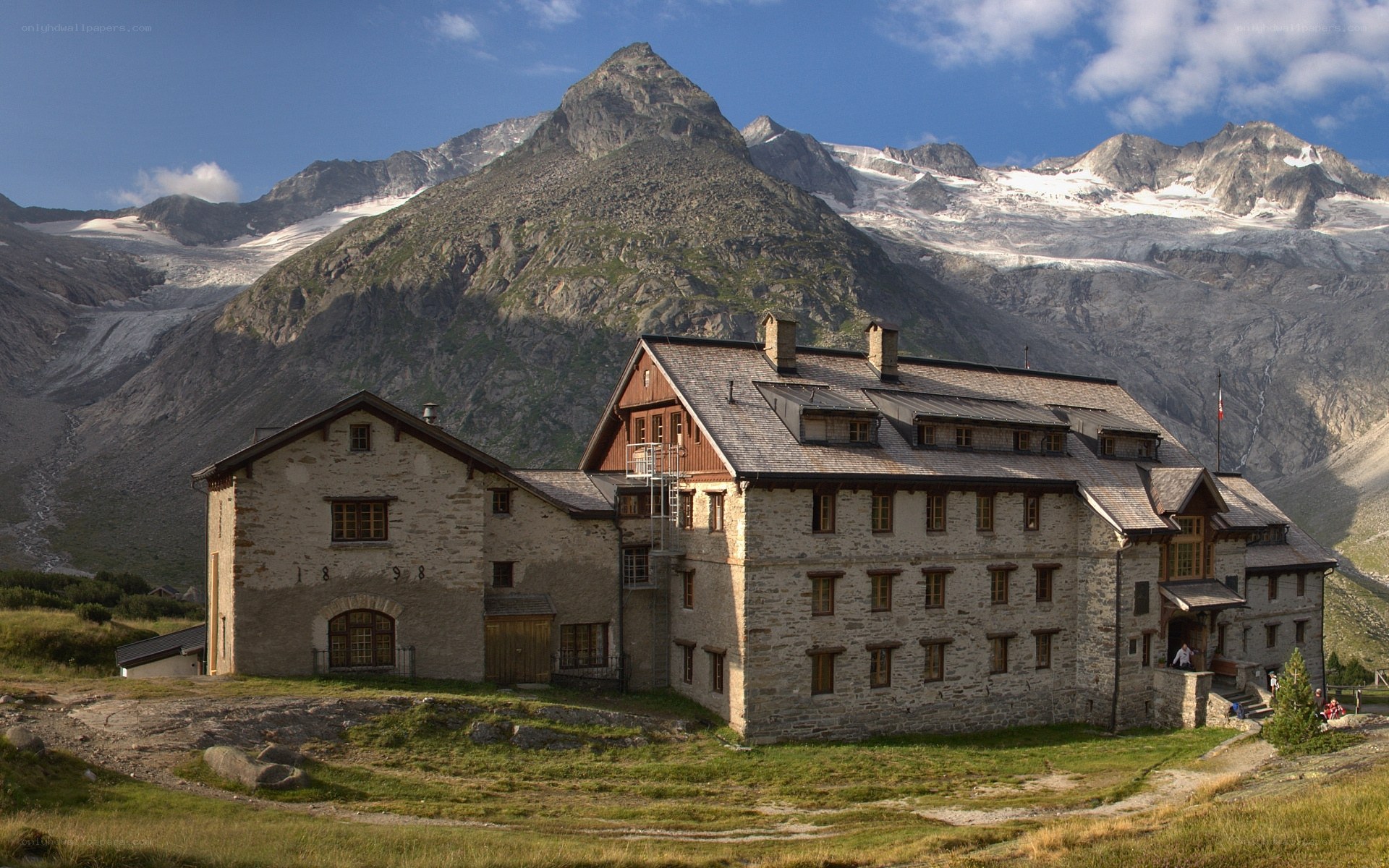 Mountain lodge with alpine backdrop