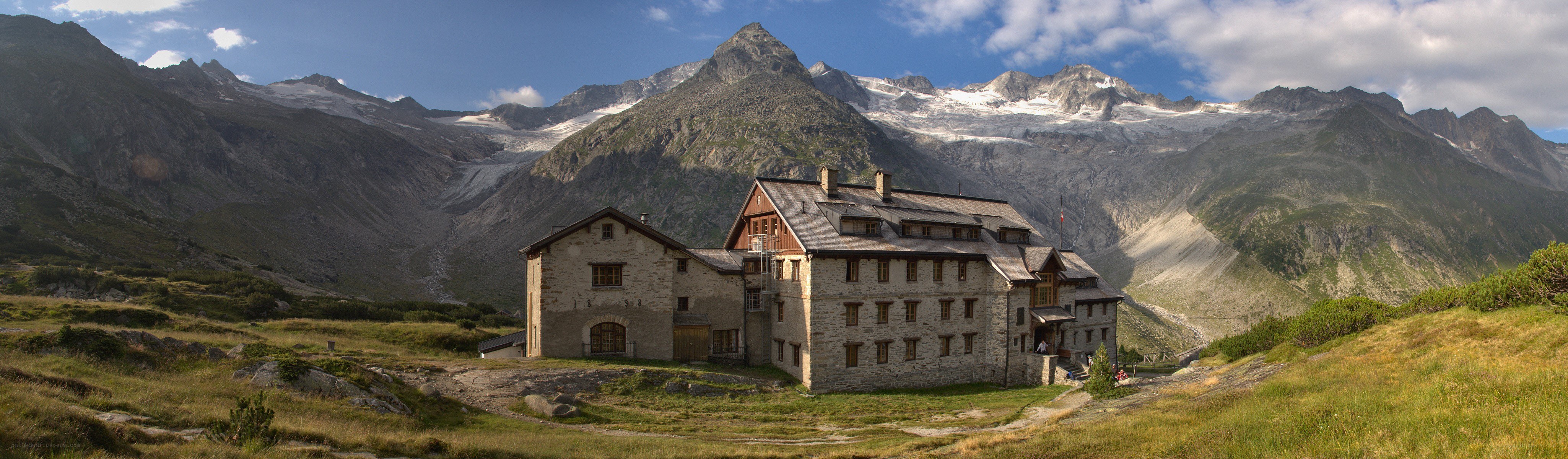 Mountain lodge with alpine peaks