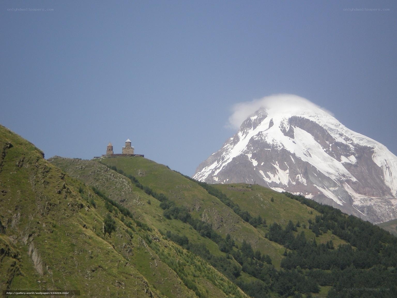 Mountain monastery with snow-capped peak