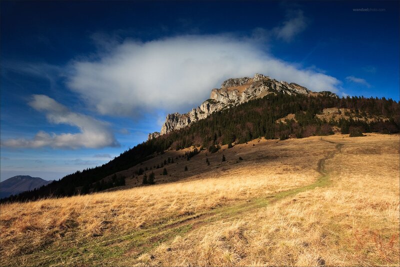 Mountain path under cloudy sky