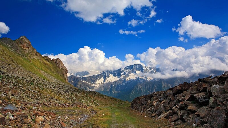 Mountain path with snow-capped peaks