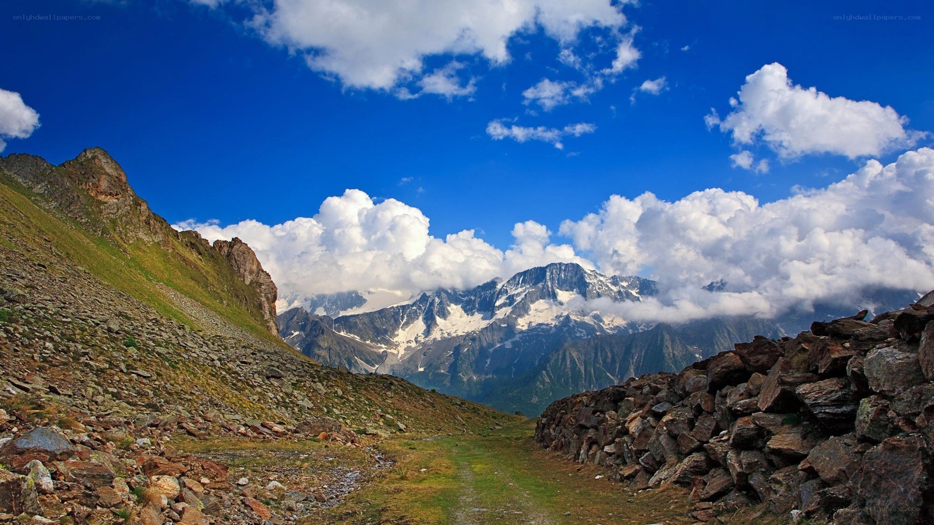 Mountain path with snow-capped peaks