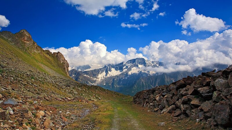 Mountain path with snow-capped peaks