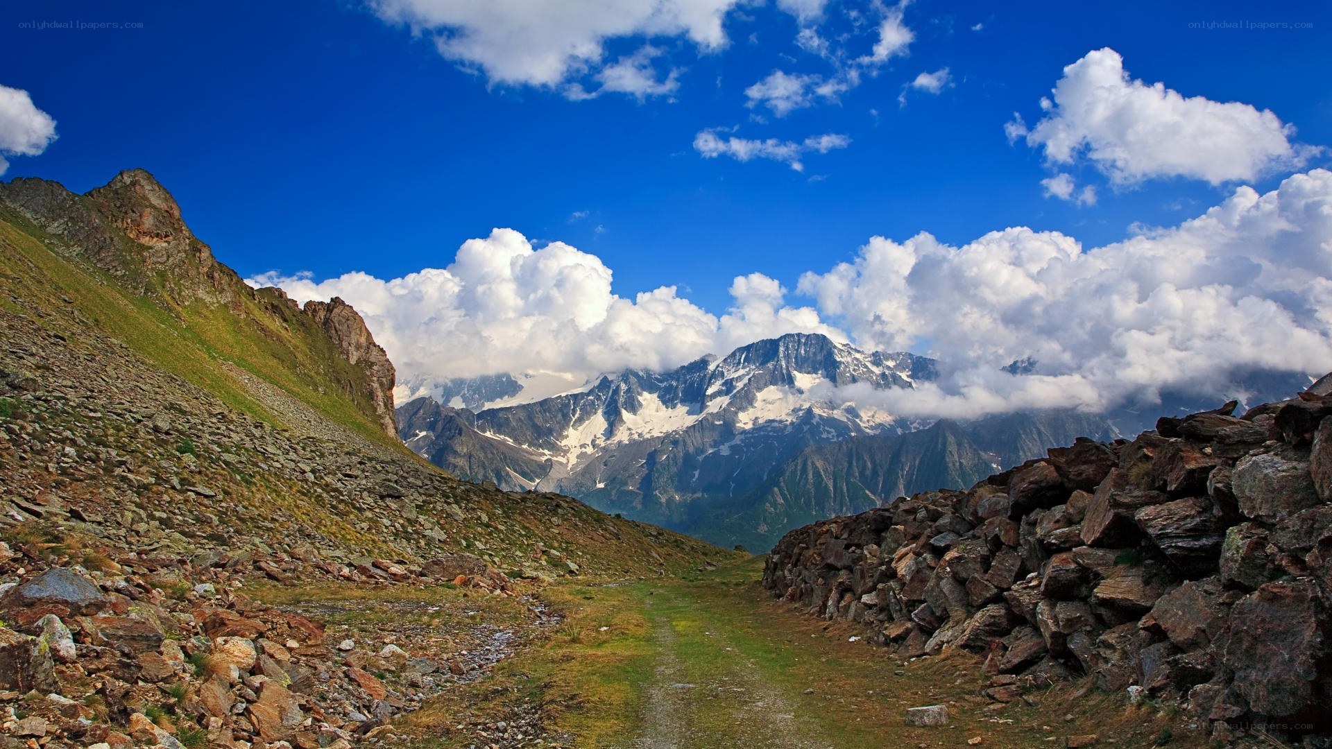 Mountain path with snow-capped peaks