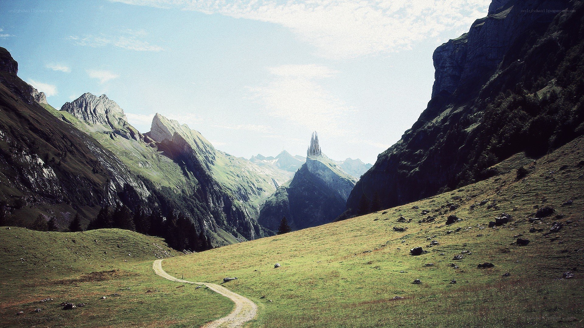 Mountain path with spire in distance