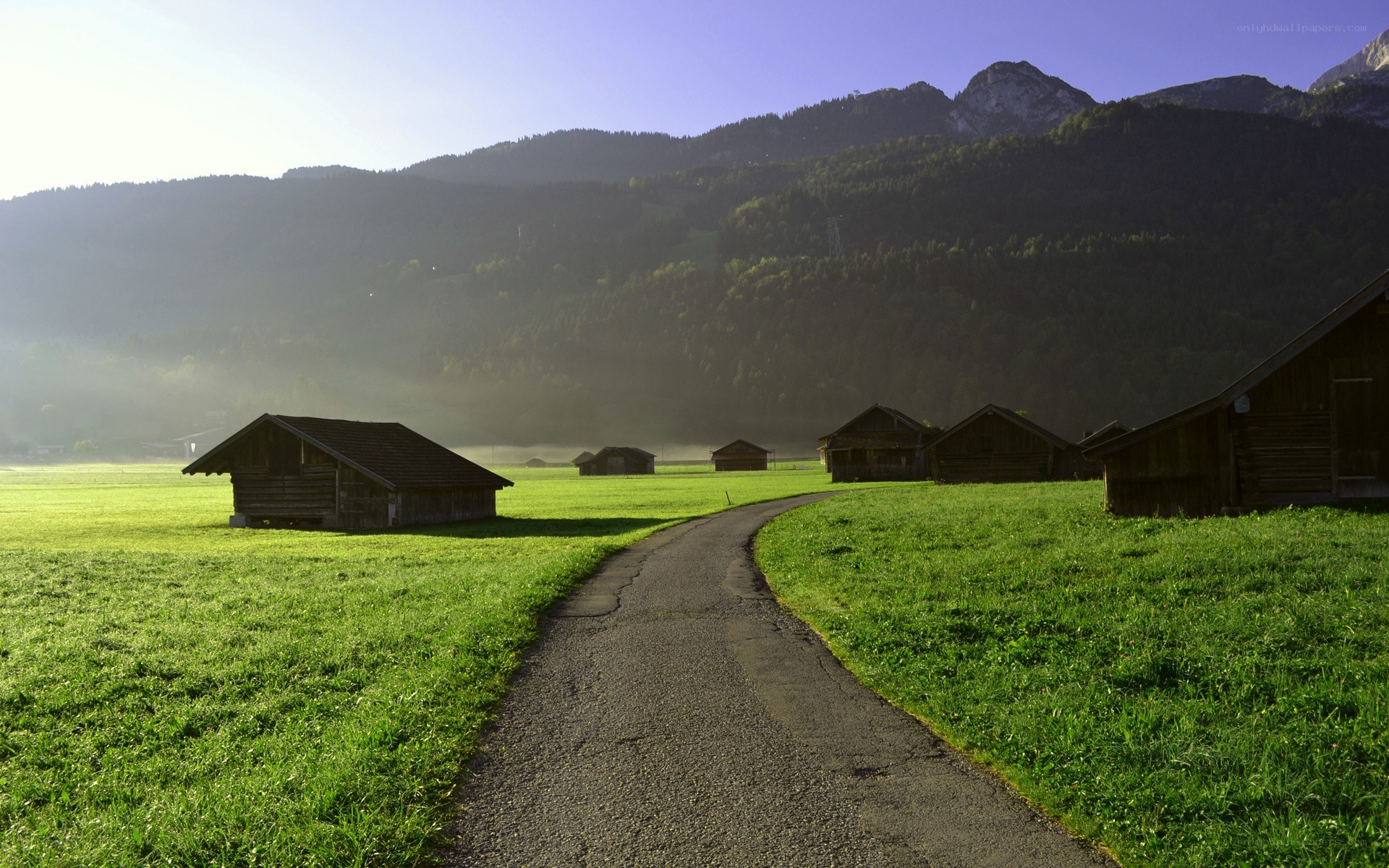Mountain path with wooden huts