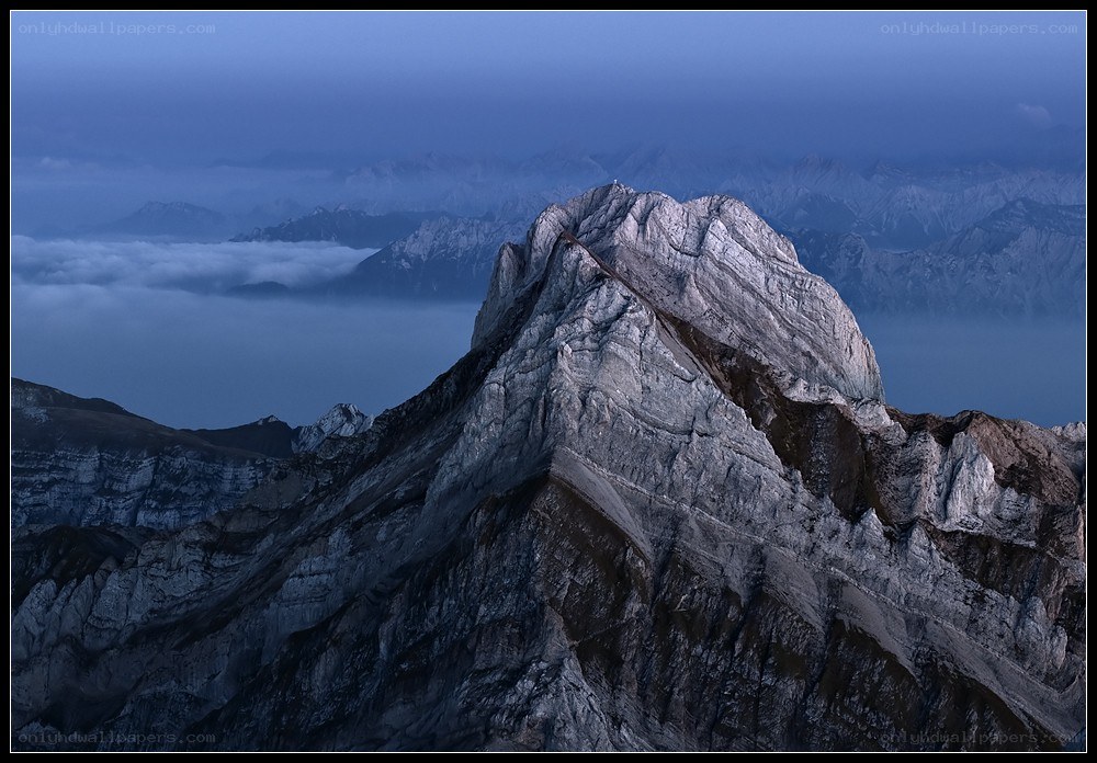 Mountain peak above clouds