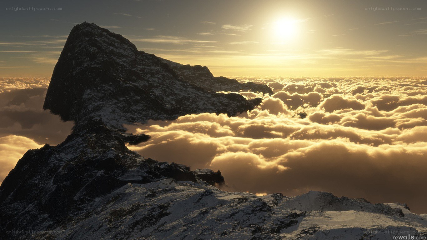Mountain peak above clouds at sunrise
