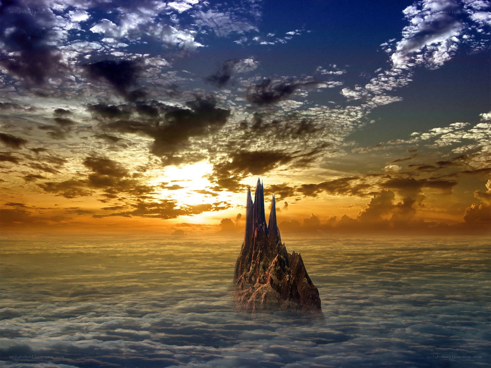 Mountain peak above clouds at sunset