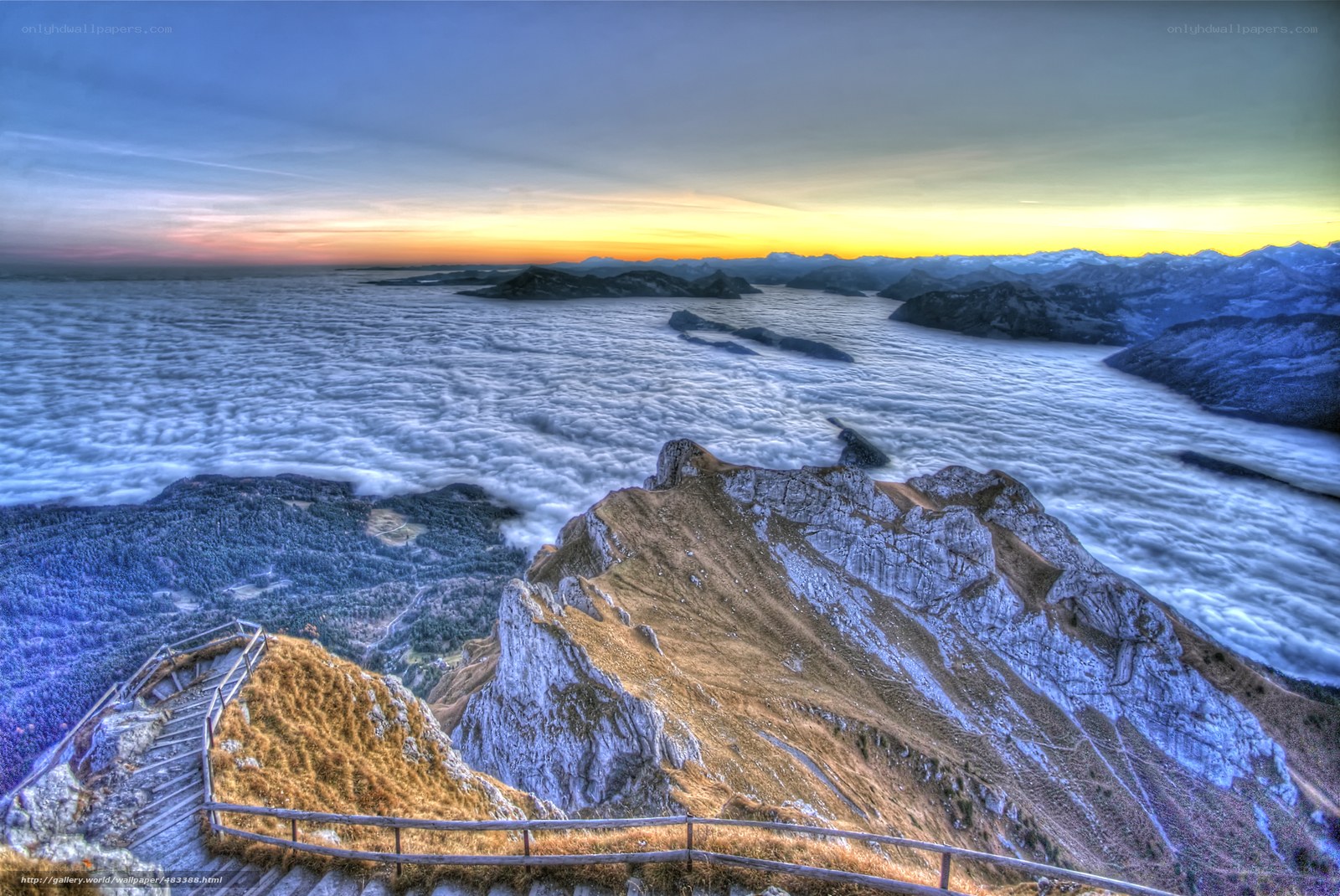 Mountain peak above clouds at sunset