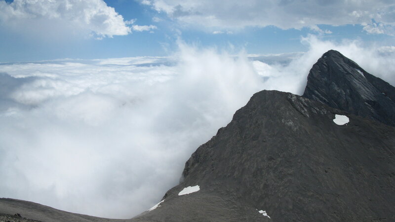 Mountain Peak Above Clouds — Gray, Dramatic, Afternoon