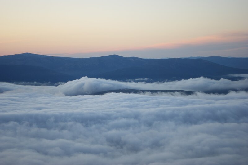 Mountain Peak Above Clouds — White, Serene, Sunset