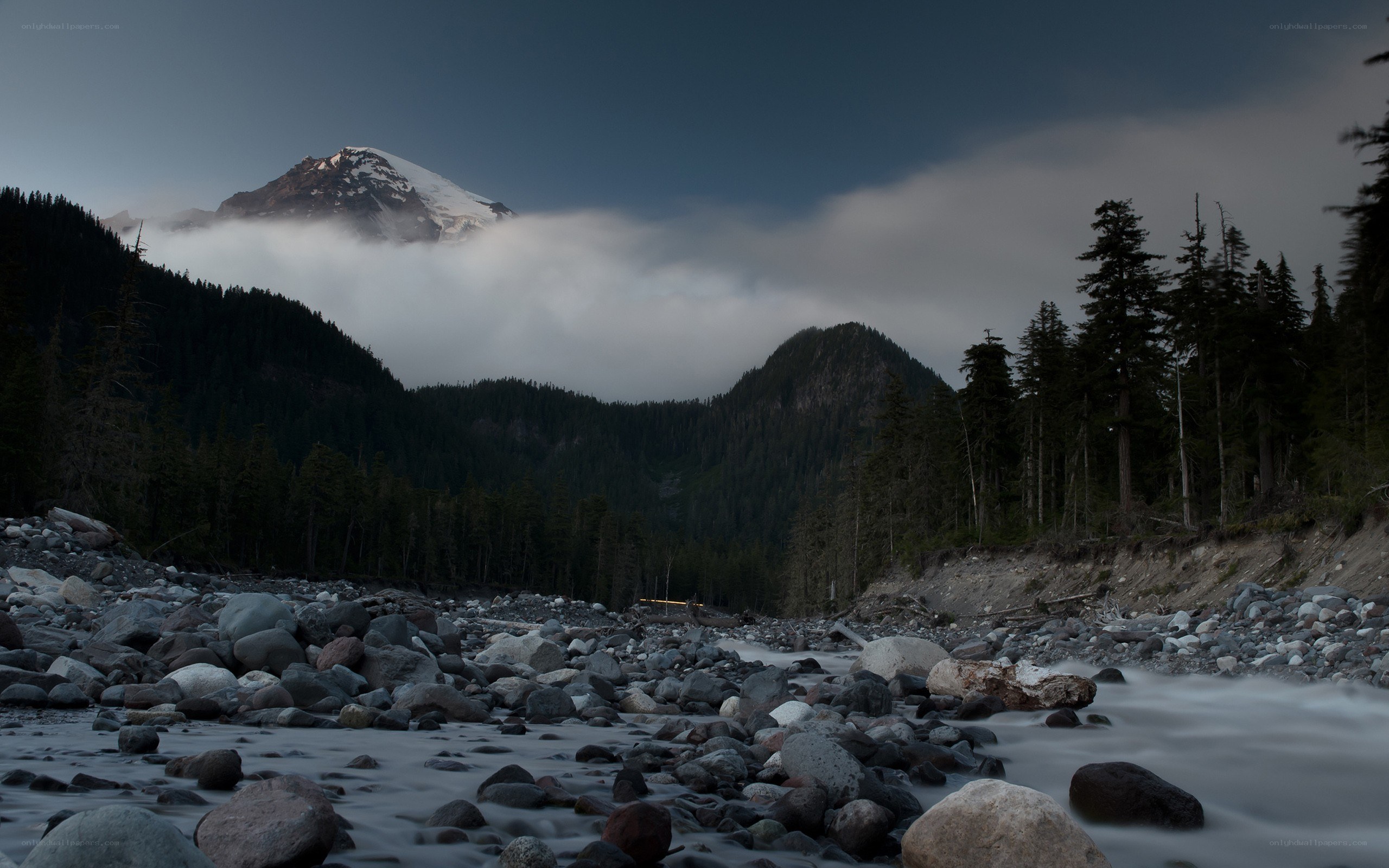 Mountain peak above river and forest