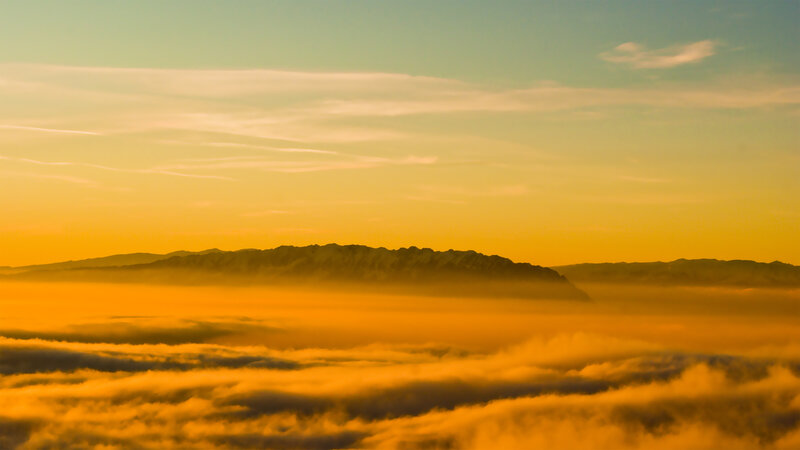 Mountain peak above sea of clouds