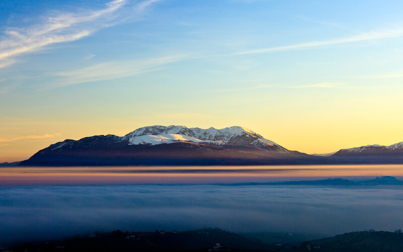 Mountain peak above sea of clouds
