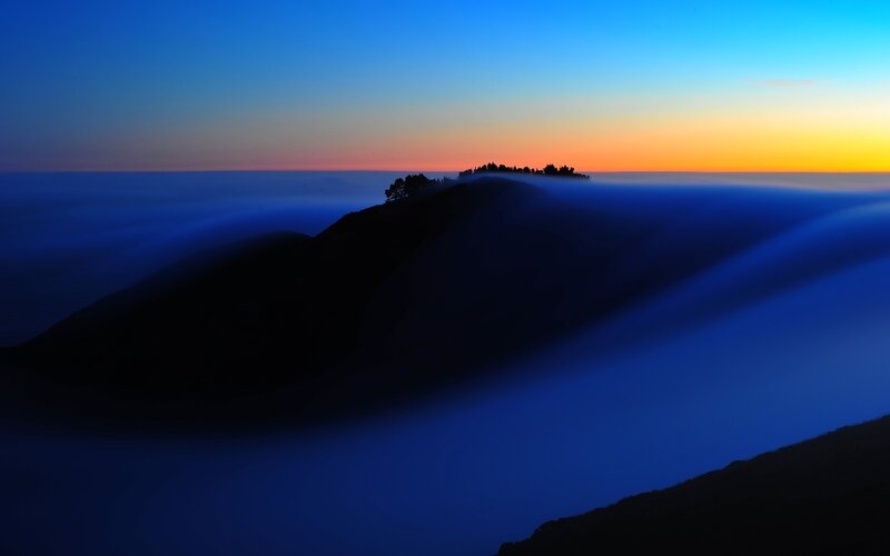 Mountain peak above sea of clouds