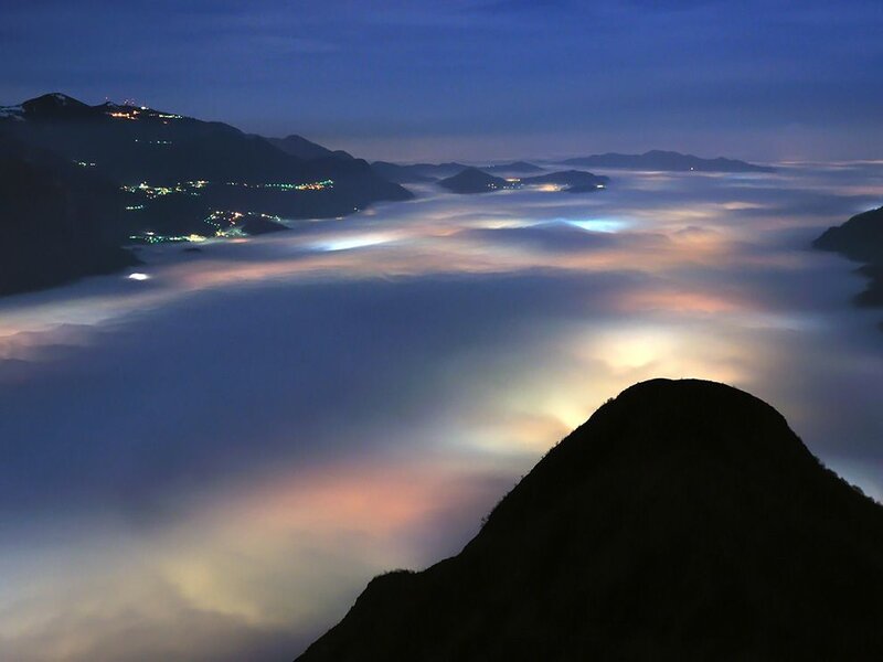 Mountain peak above sea of clouds