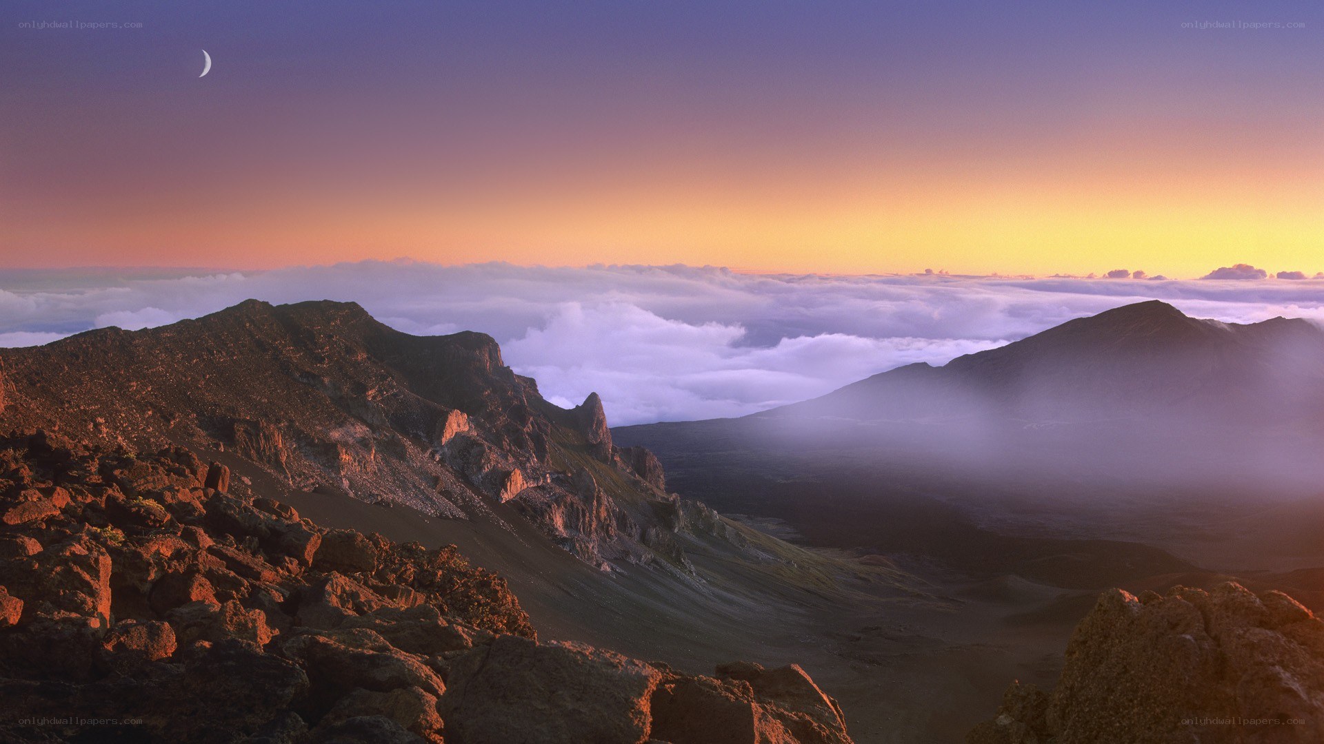 Mountain peak at sunrise with moon