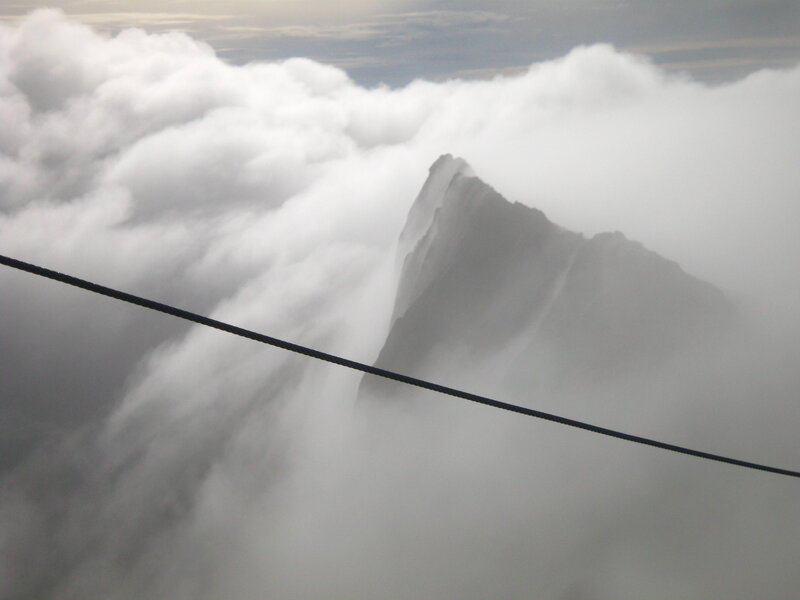 Mountain Peak in Clouds — White, Dramatic