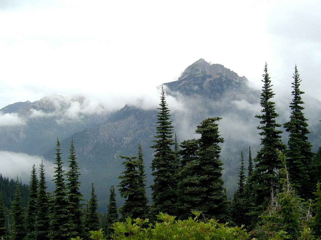 Mountain peak through clouds