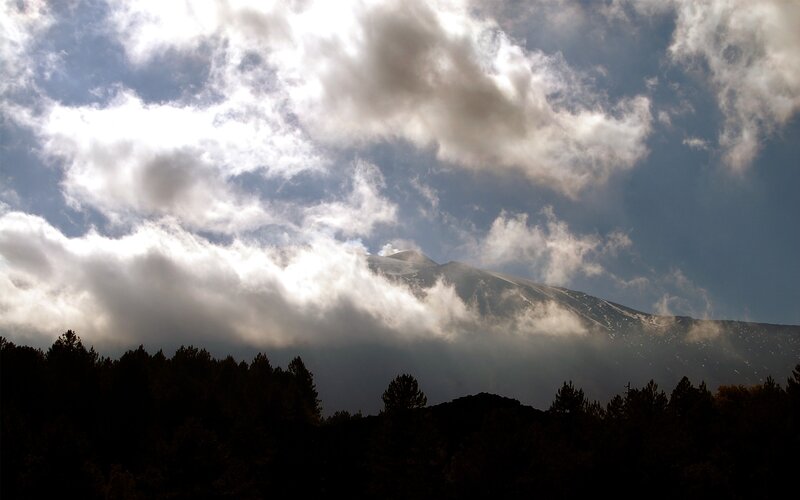Mountain peak through clouds