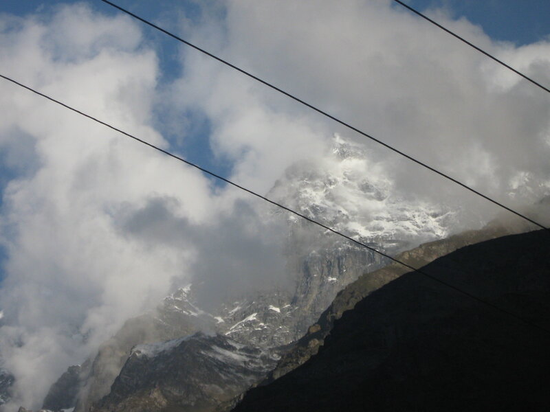 Mountain peak through clouds