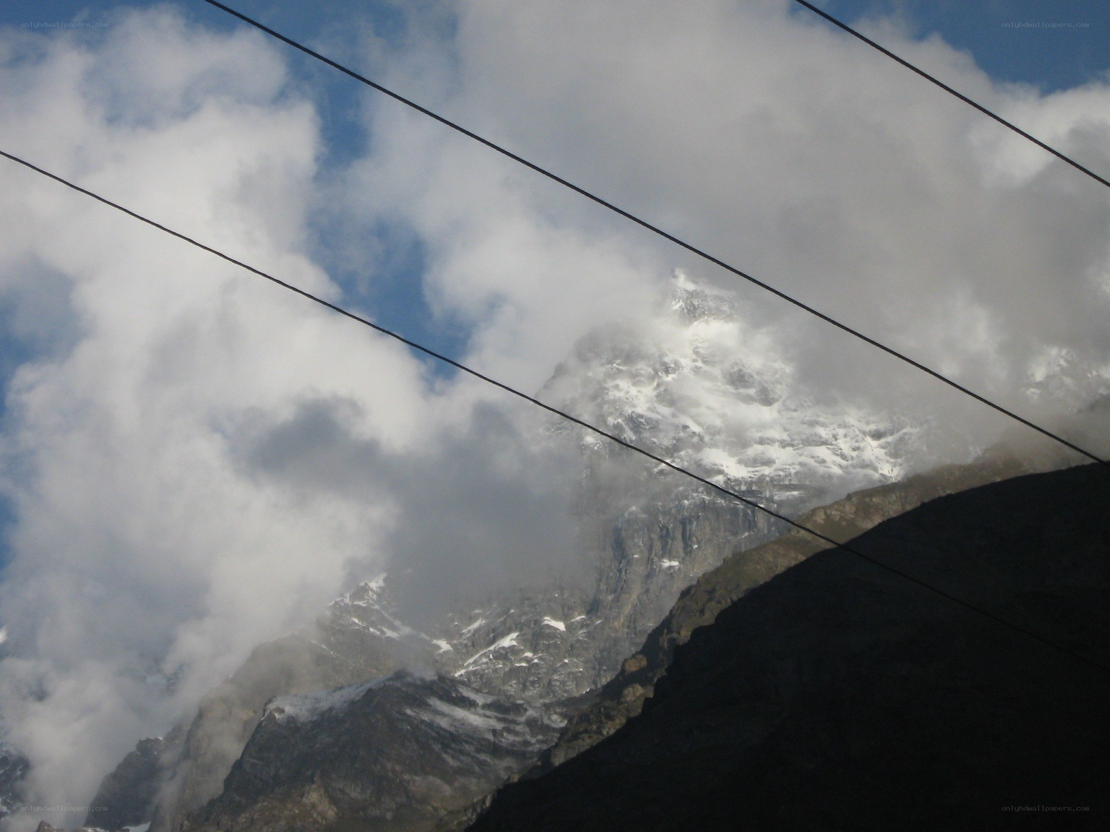 Mountain peak through clouds