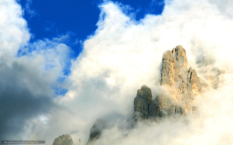Mountain peak through clouds
