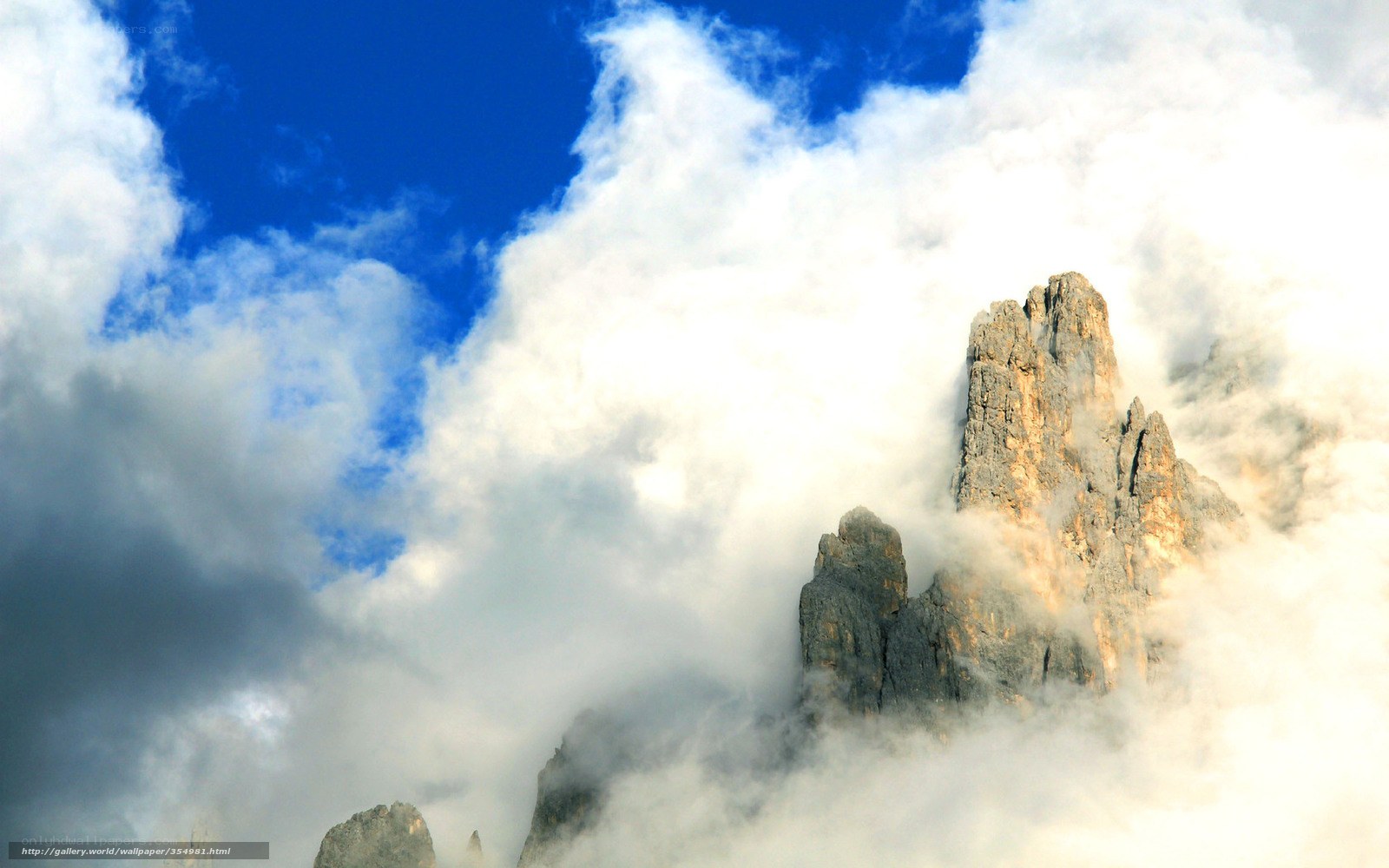 Mountain peak through clouds