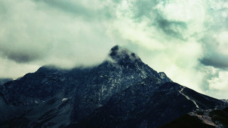 Mountain peak under cloudy sky