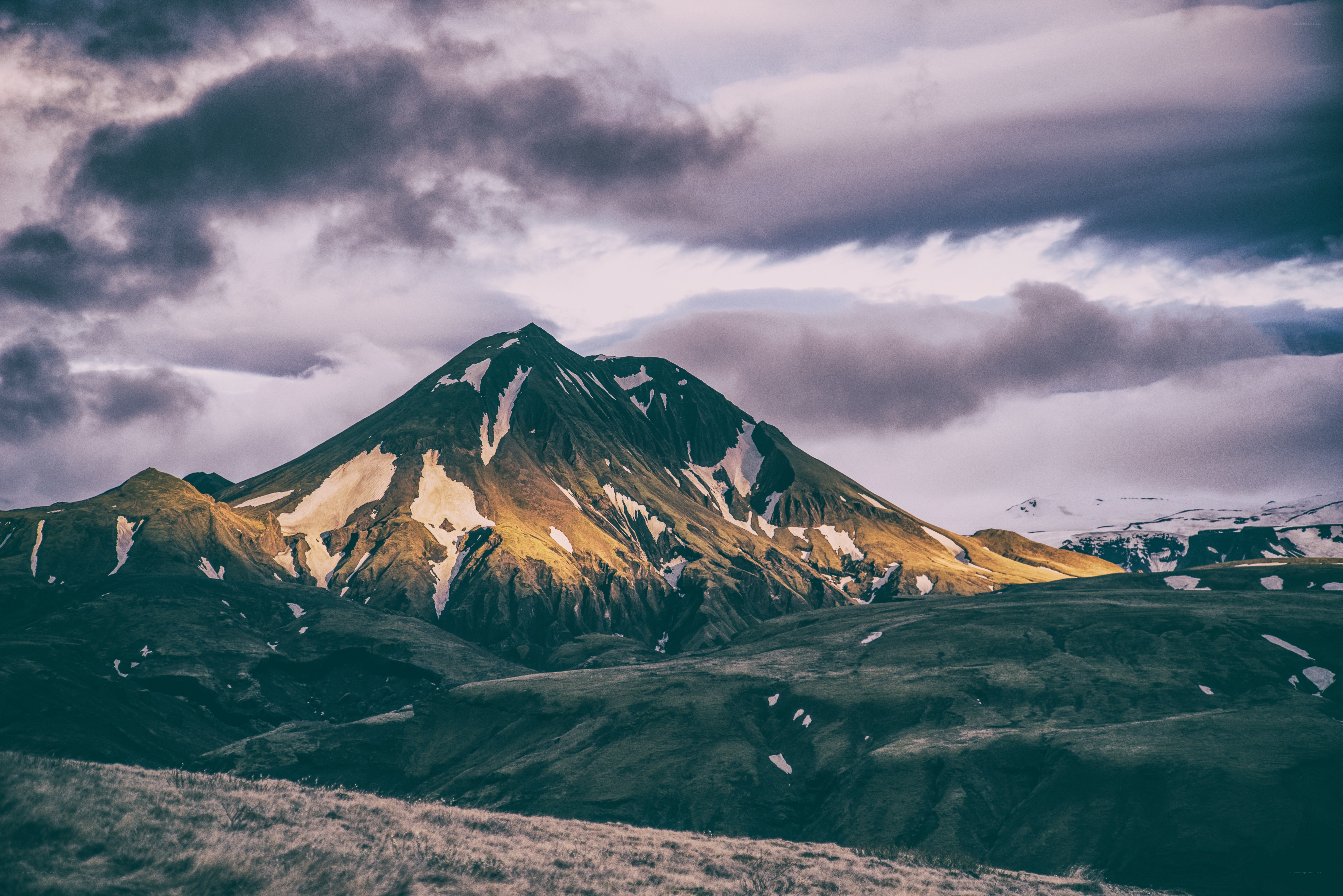 Mountain peak under cloudy sky