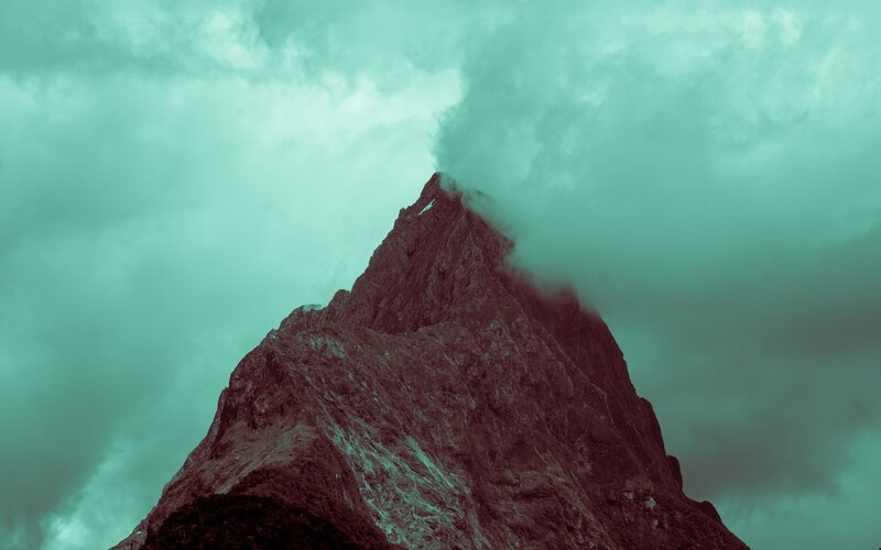 Mountain peak under cloudy sky