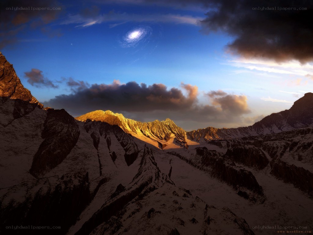 Mountain peak under spiral galaxy