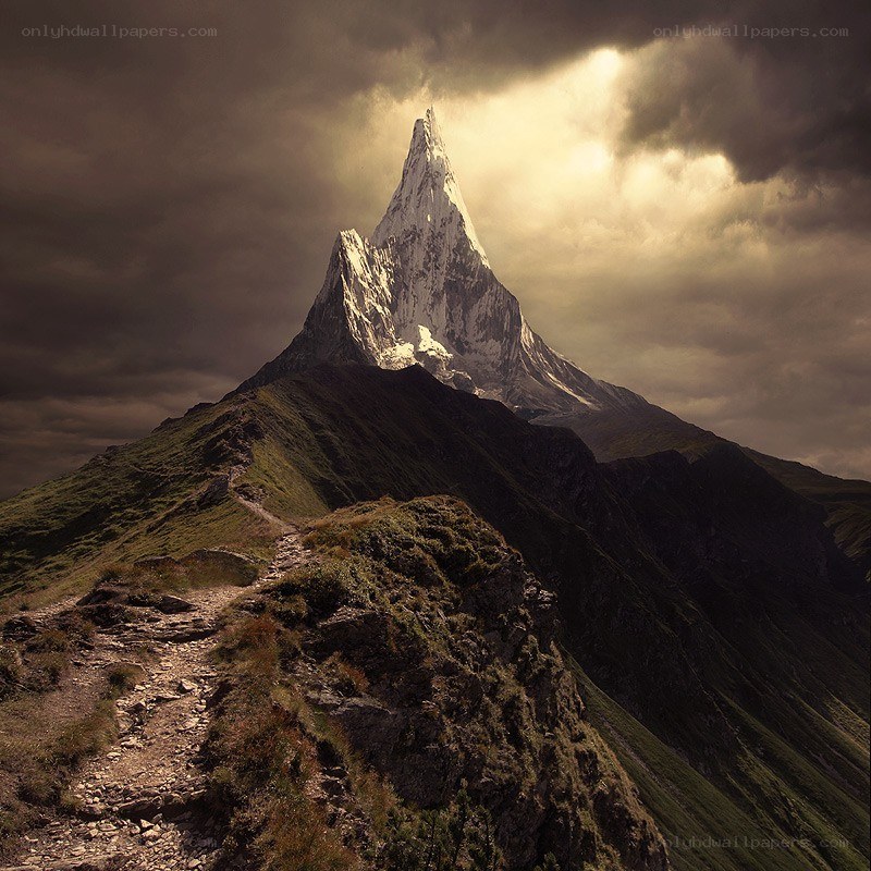 Mountain peak under stormy sky