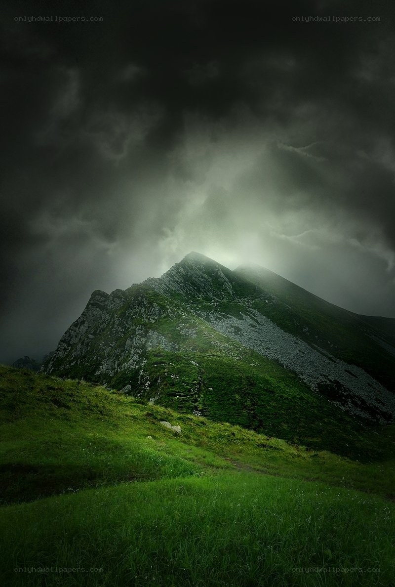 Mountain peak under stormy sky
