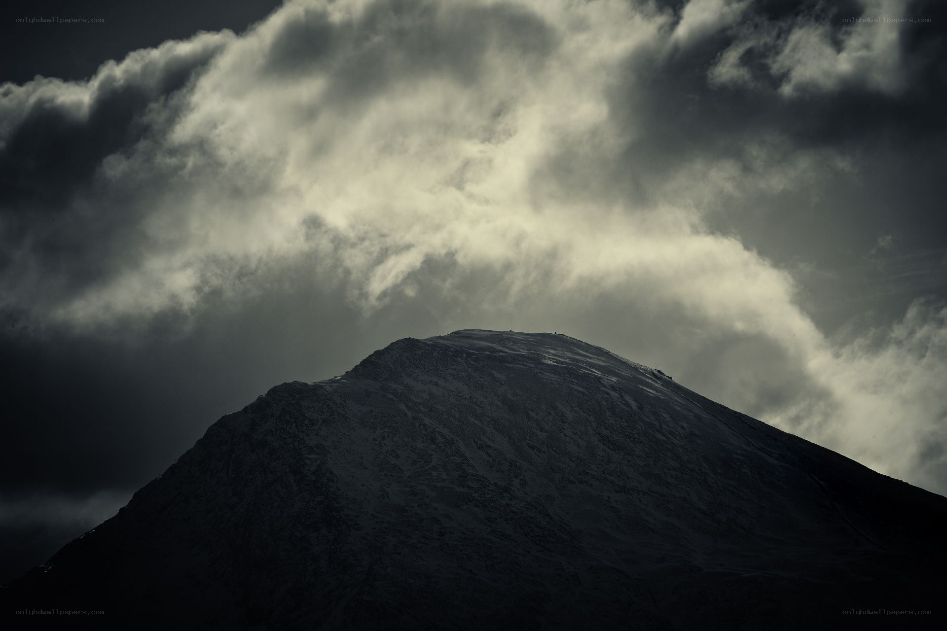 Mountain peak under stormy sky