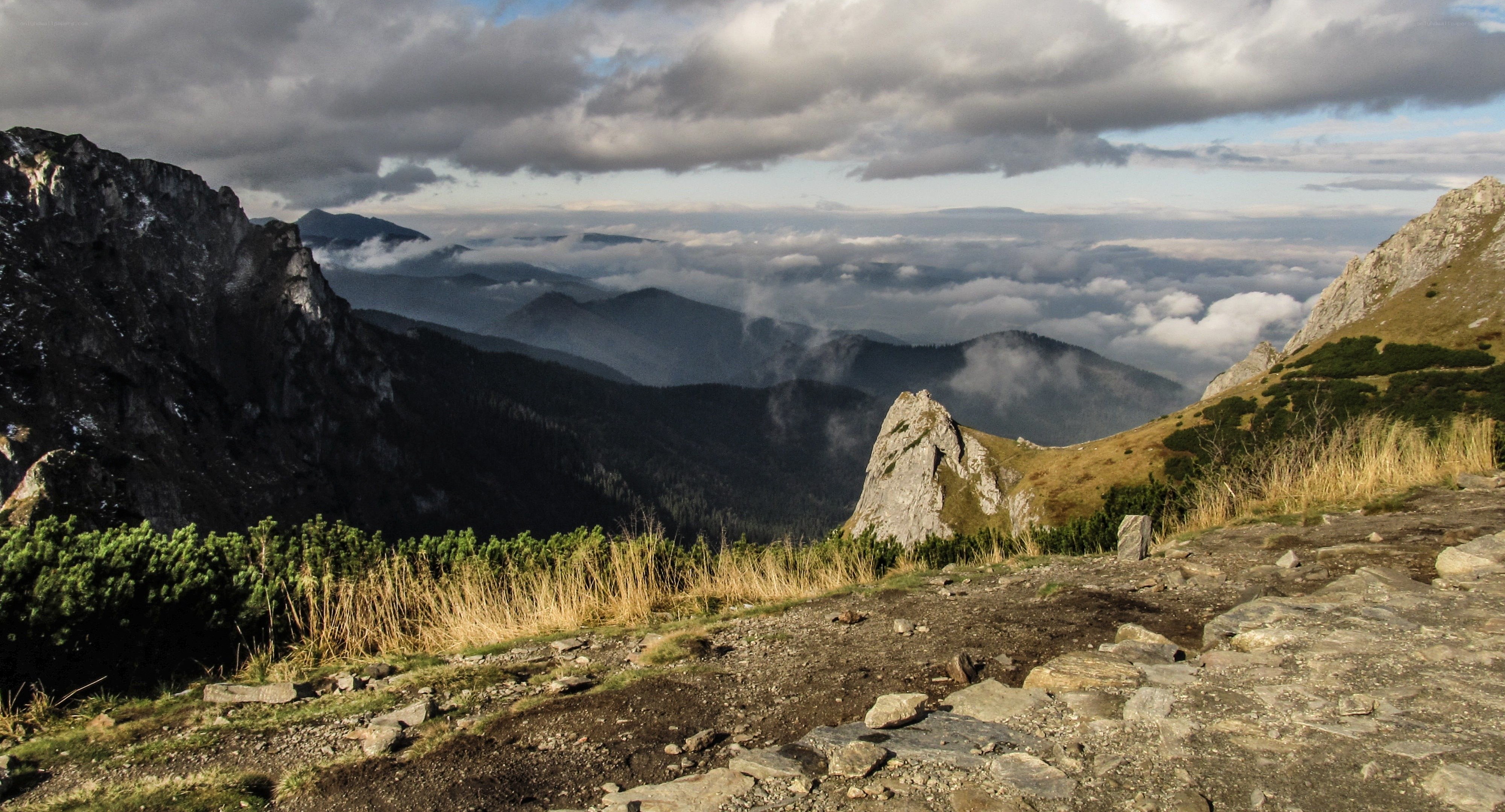 Mountain peak with clouds below