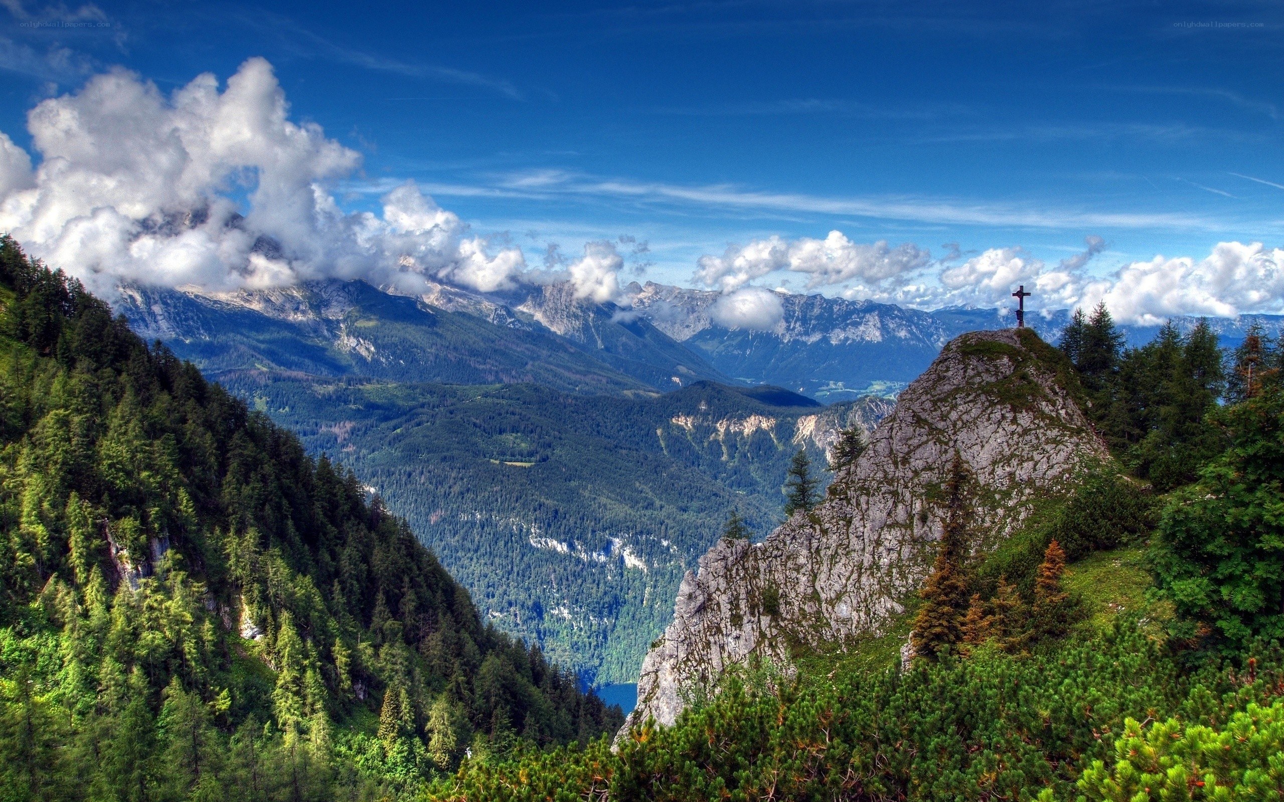 Mountain peak with cross and valley
