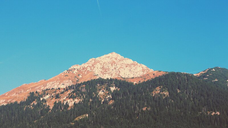 Mountain Peak with Forest — Blue, Serene, Afternoon, Photograph, Sky, Airplane Contrail