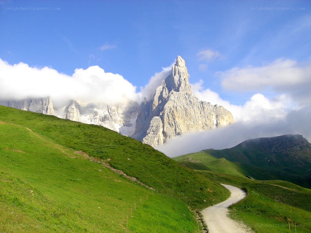Mountain peak with green hills