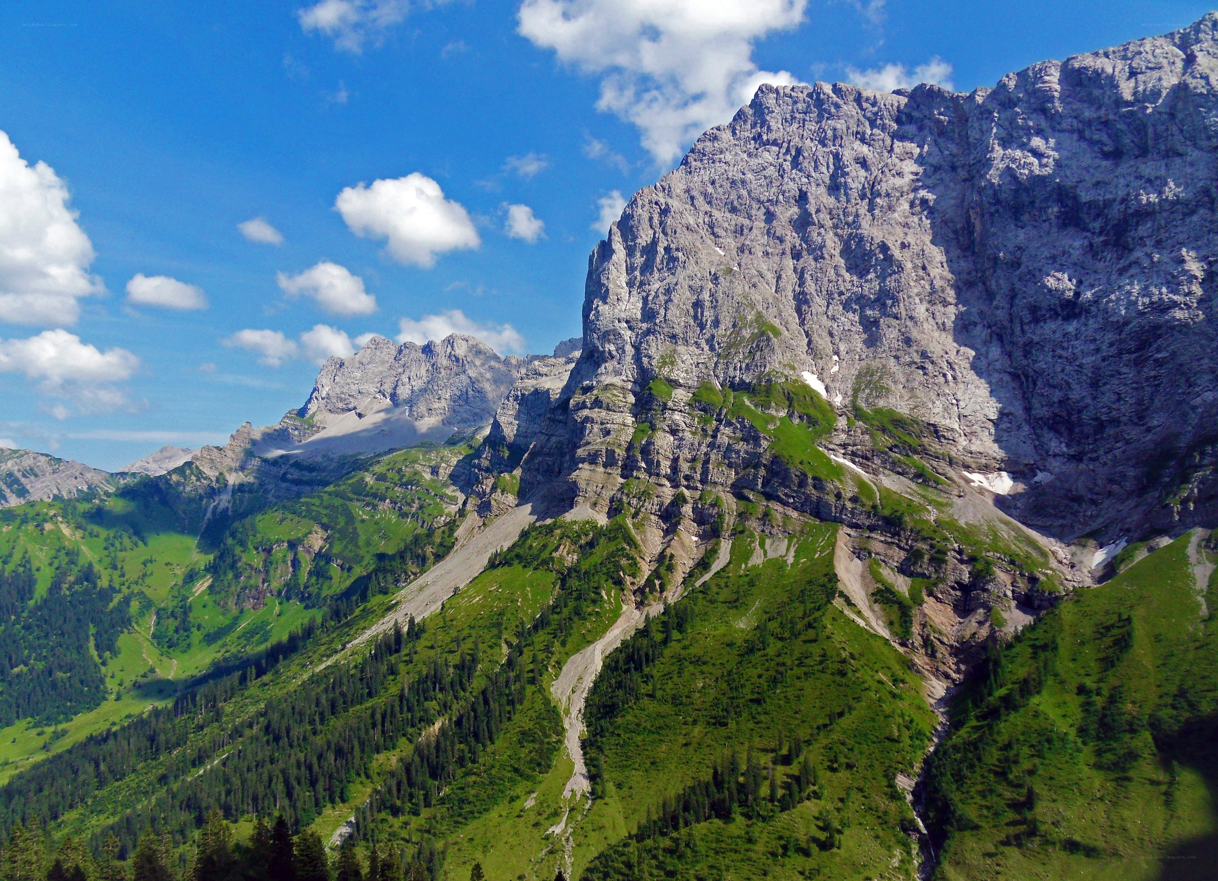 Mountain peak with green slopes