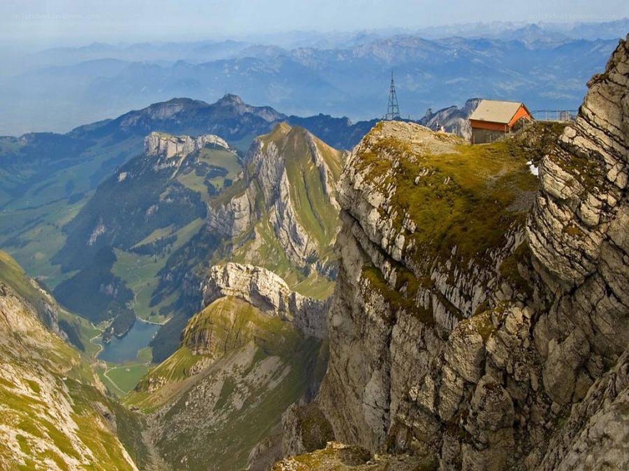 Mountain peak with hut and valley view