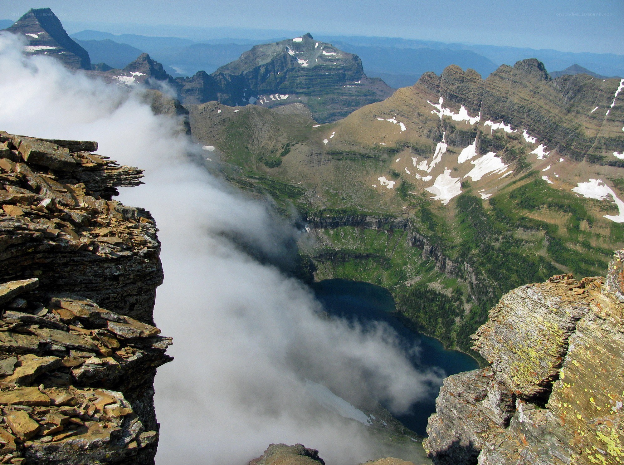 Mountain peak with lake and clouds