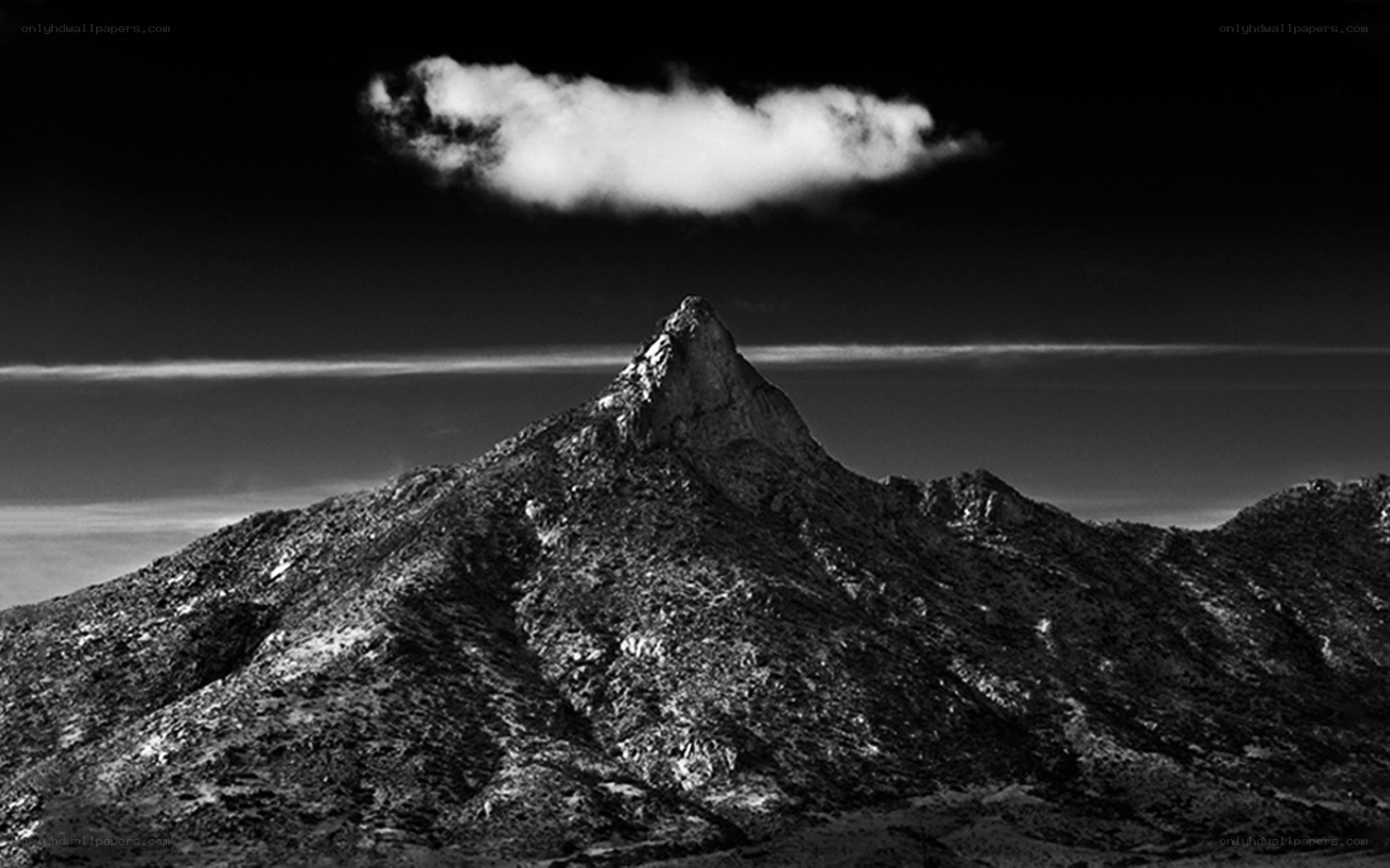 Mountain peak with solitary cloud